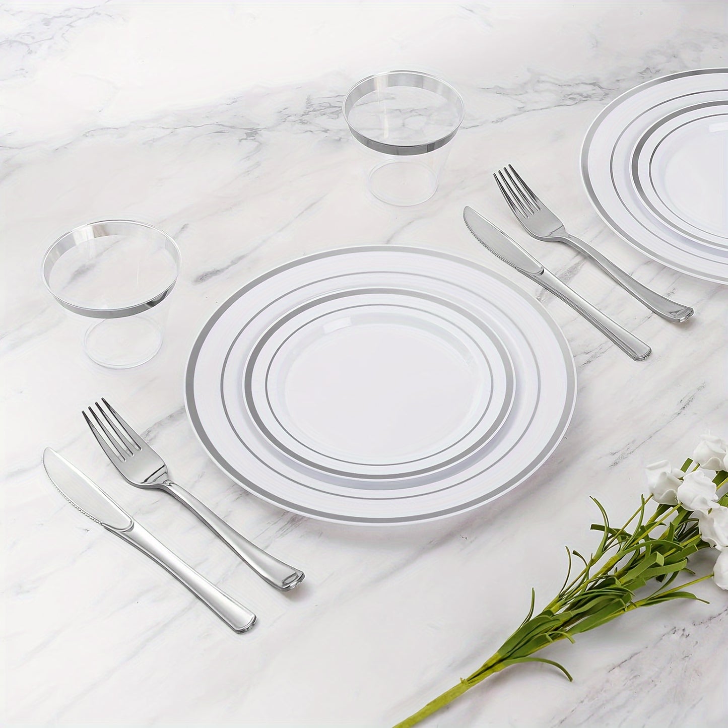 A Set Of Silvery Disposable Tableware For Weddings And Parties